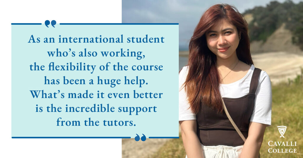 A female international Health and Wellbeing student standing on a beach.
